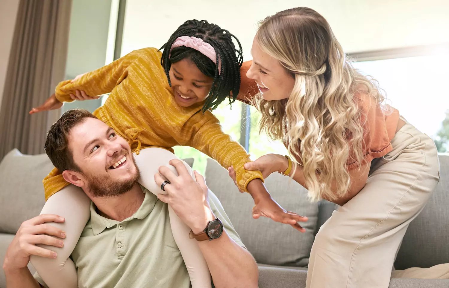 Couple laughing with their foster child