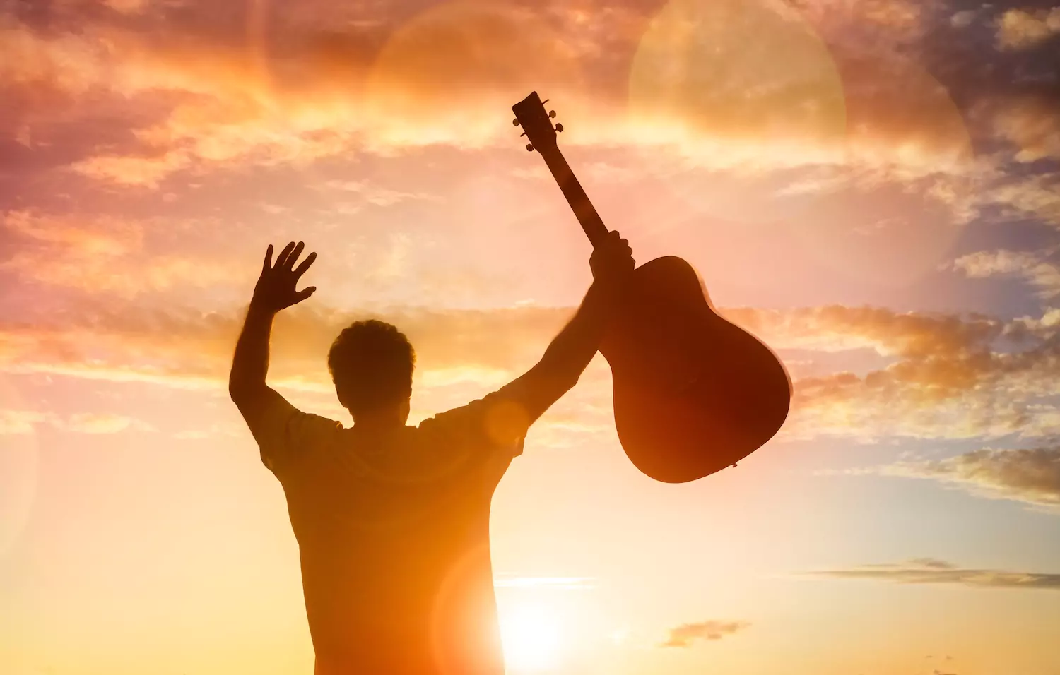 Man holding up a guitar