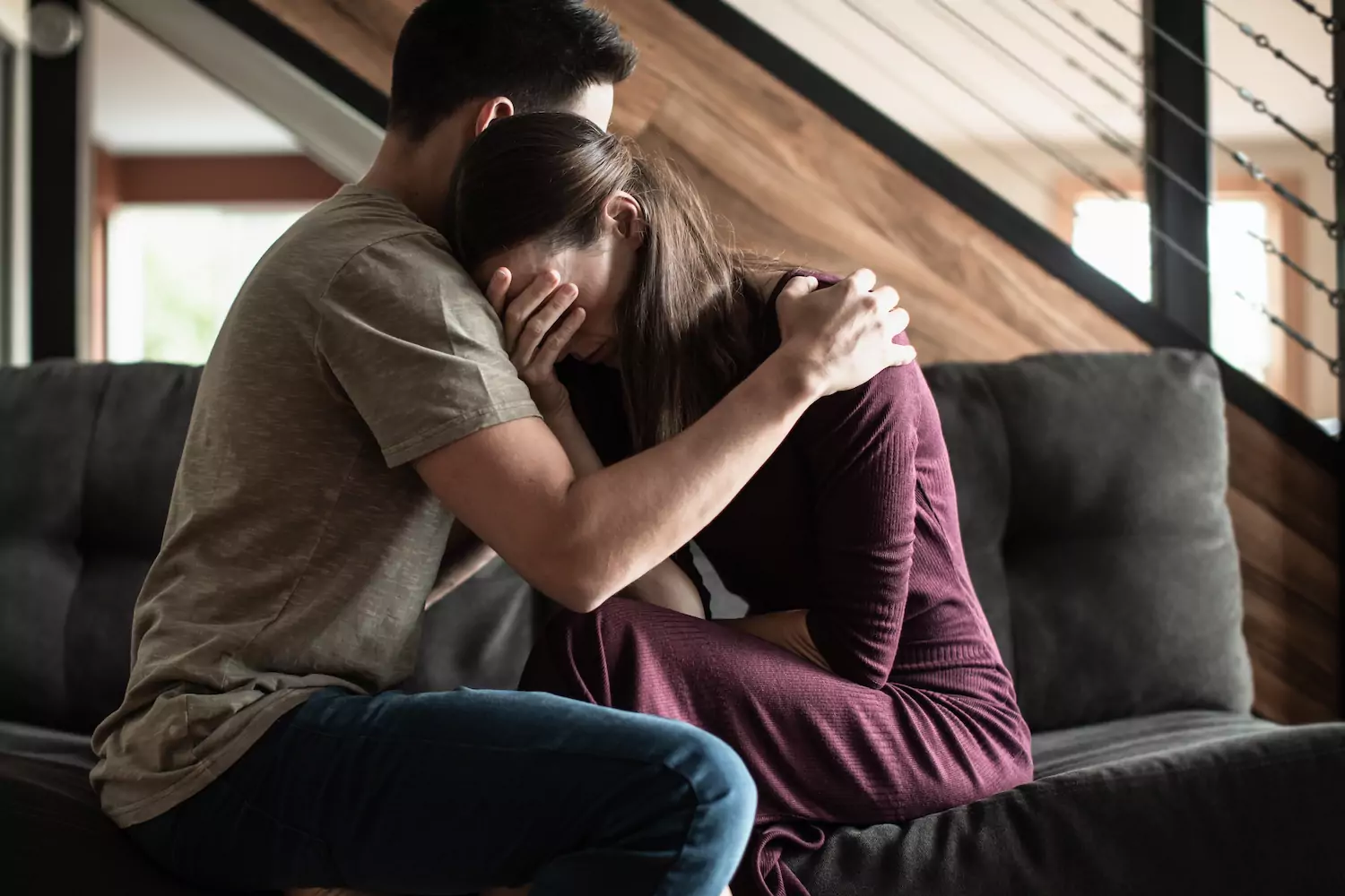 Husband holding his crying wife