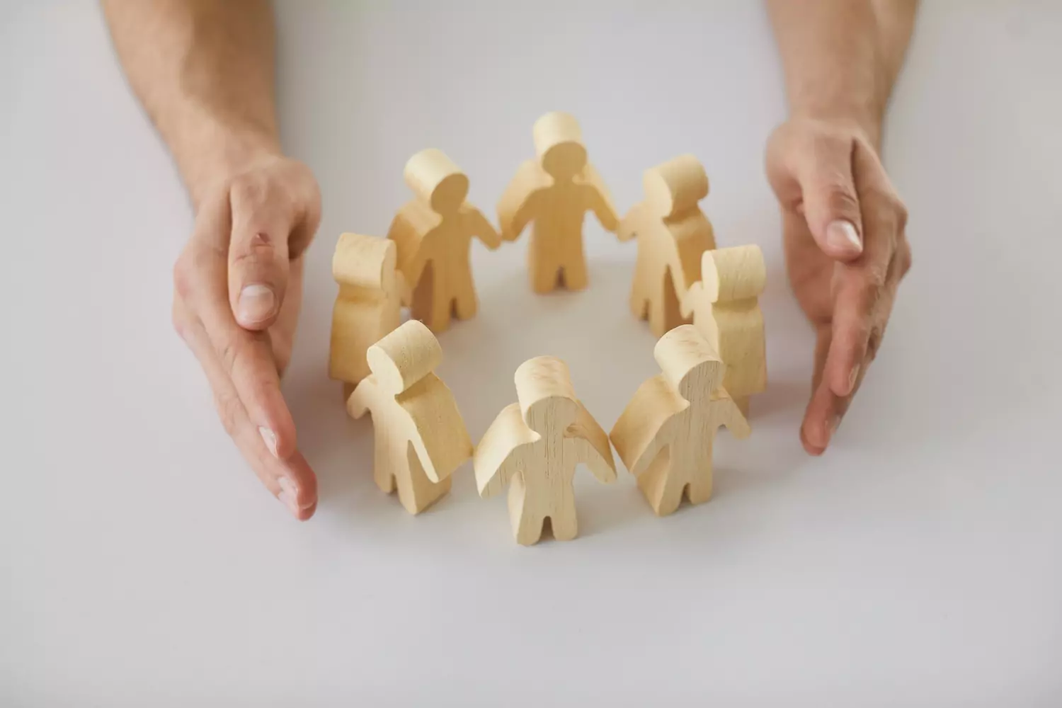 little wooden children arranged in a circle