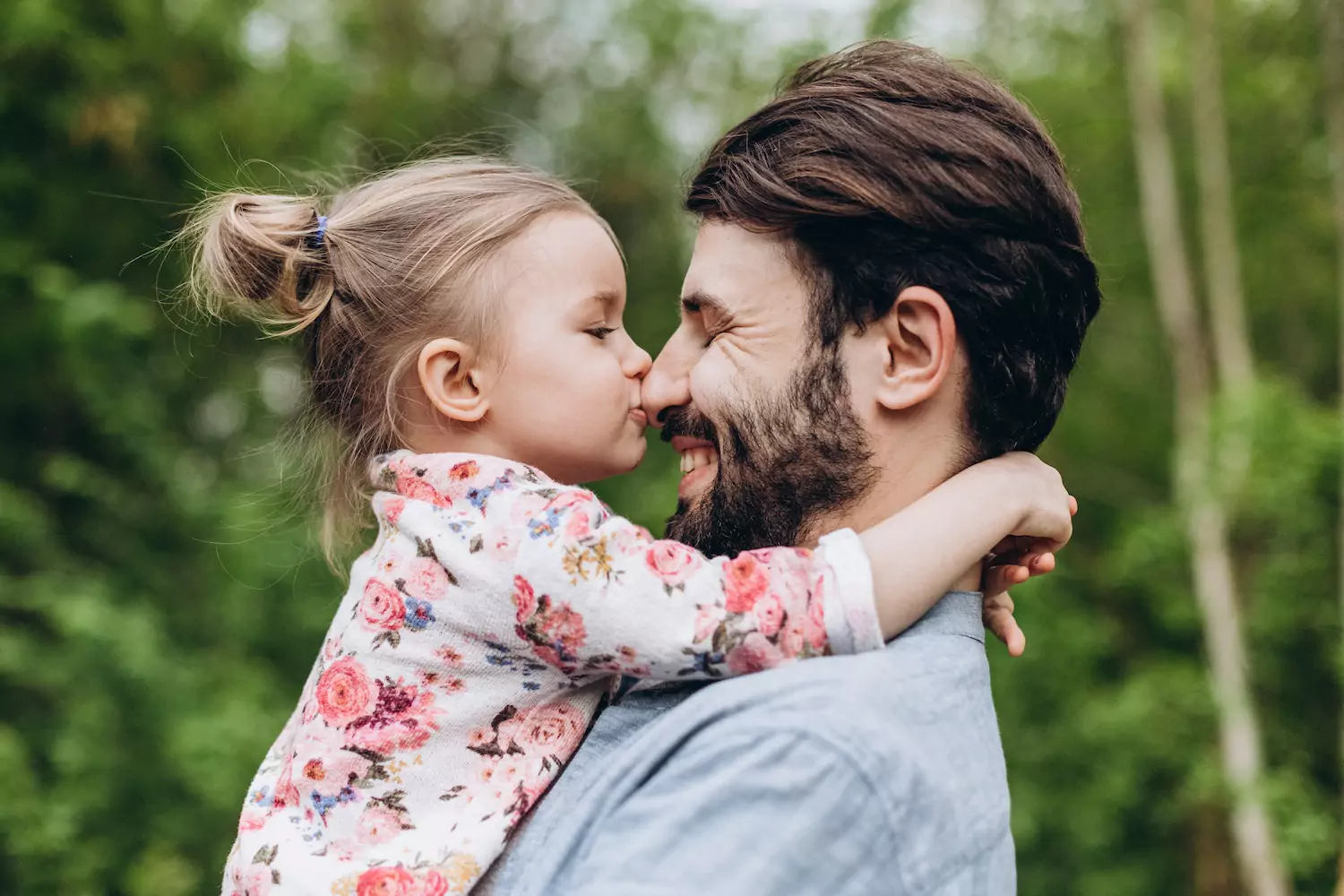 Father And Daughter Having Fun In Park. Parent And His Child Relaxing And Spending Leisure Time Together Outdoors In Nature, highlighting the importance of family.