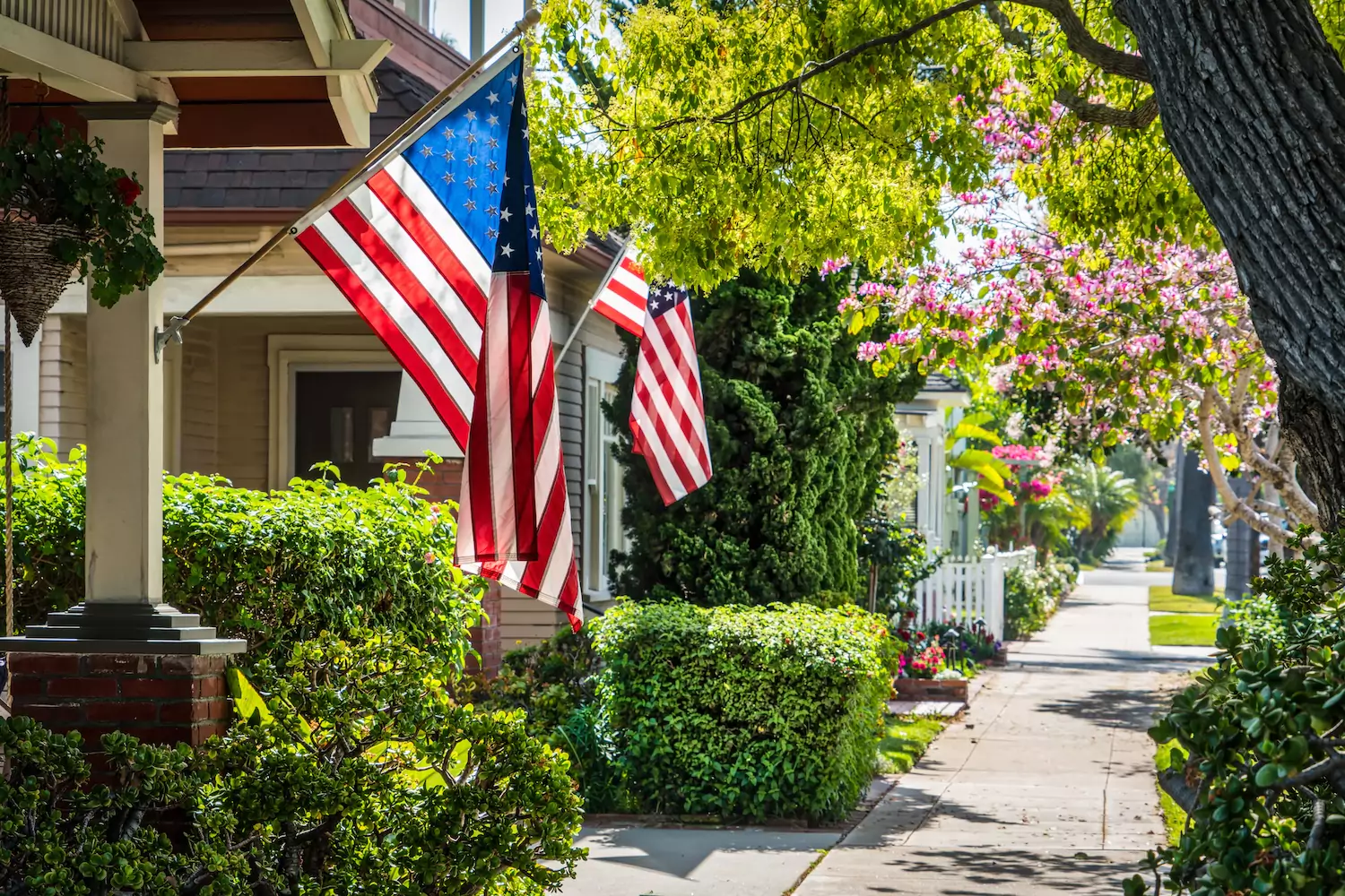 a row of homes with American flags symbolizing the American dream