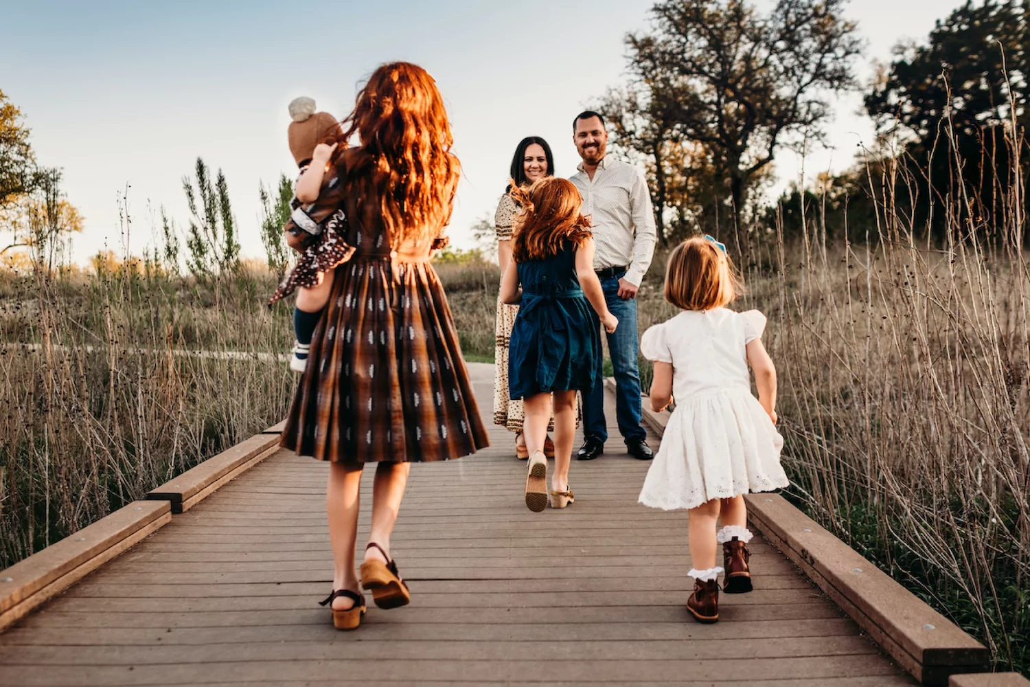 a family with foster and adopted kids walking outside together