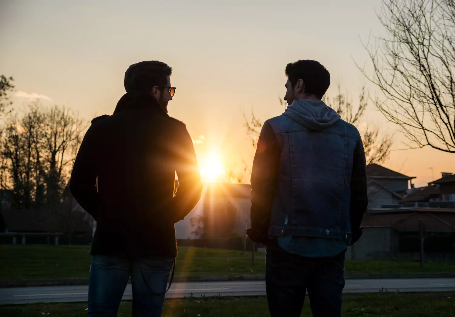 Two men talk outside at dusk, resolving conflict biblically.