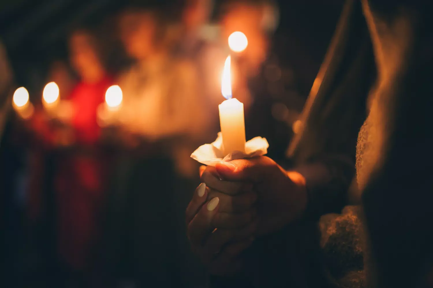 Churchgoers hold lit candles at a Christmas Eve service.