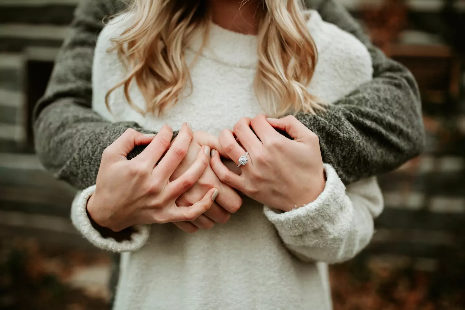 A pastor wraps his arms around his wife from behind, caring for her in a weary season.