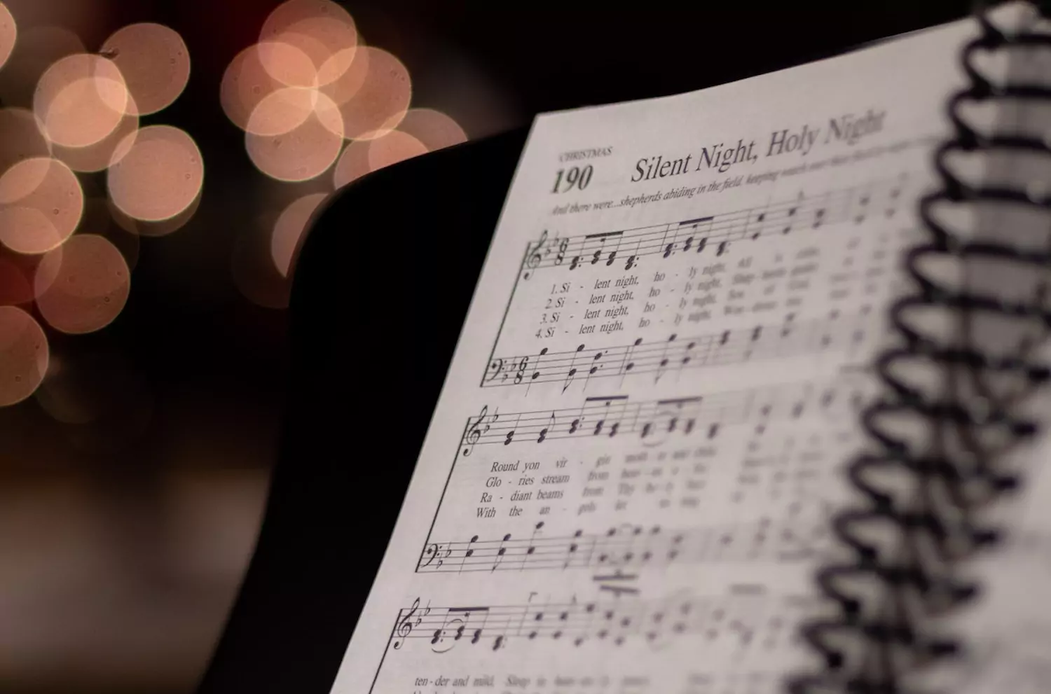 A book of Christmas music sits at a piano.
