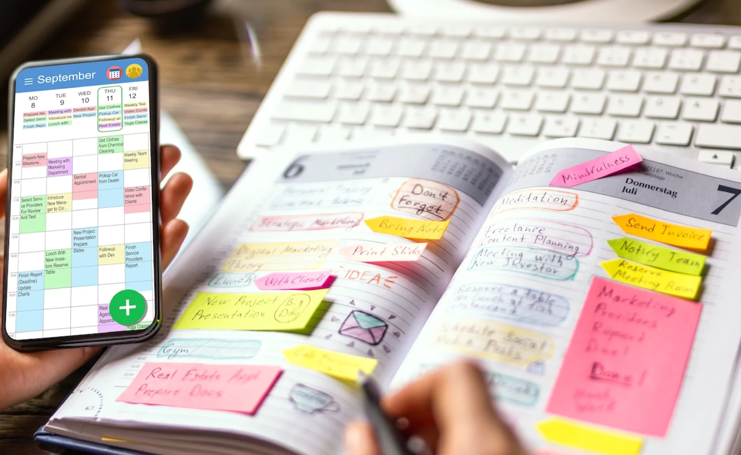 A pastor creates a new weekly schedule using a planner and his phone.