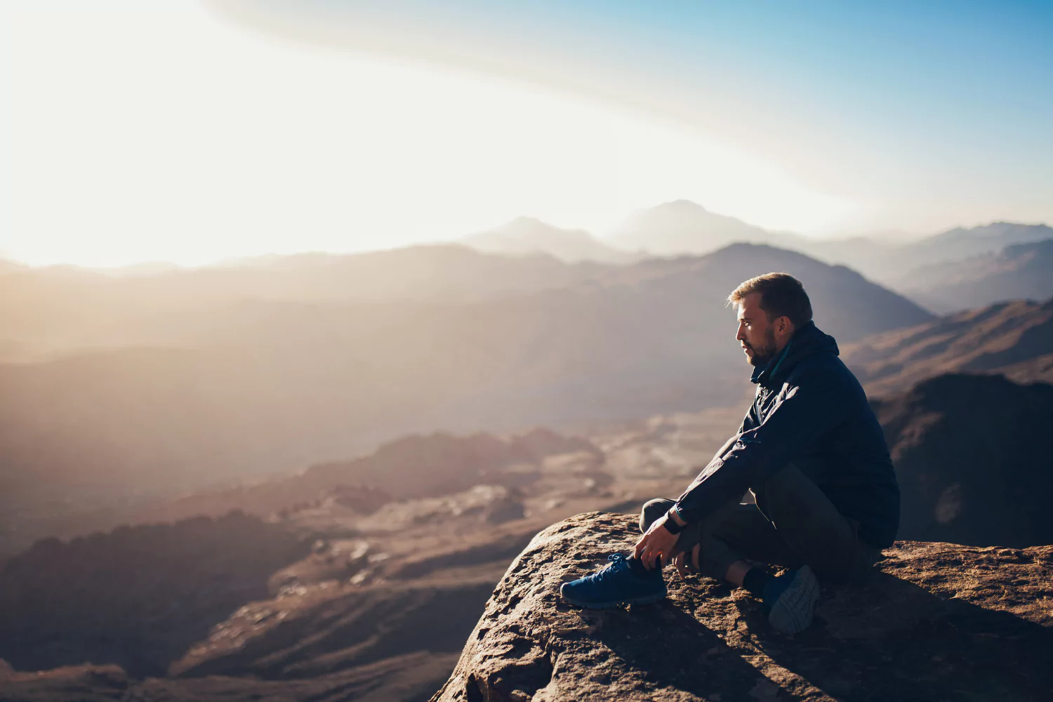 Man resting after exhausting hike, showing how to rest