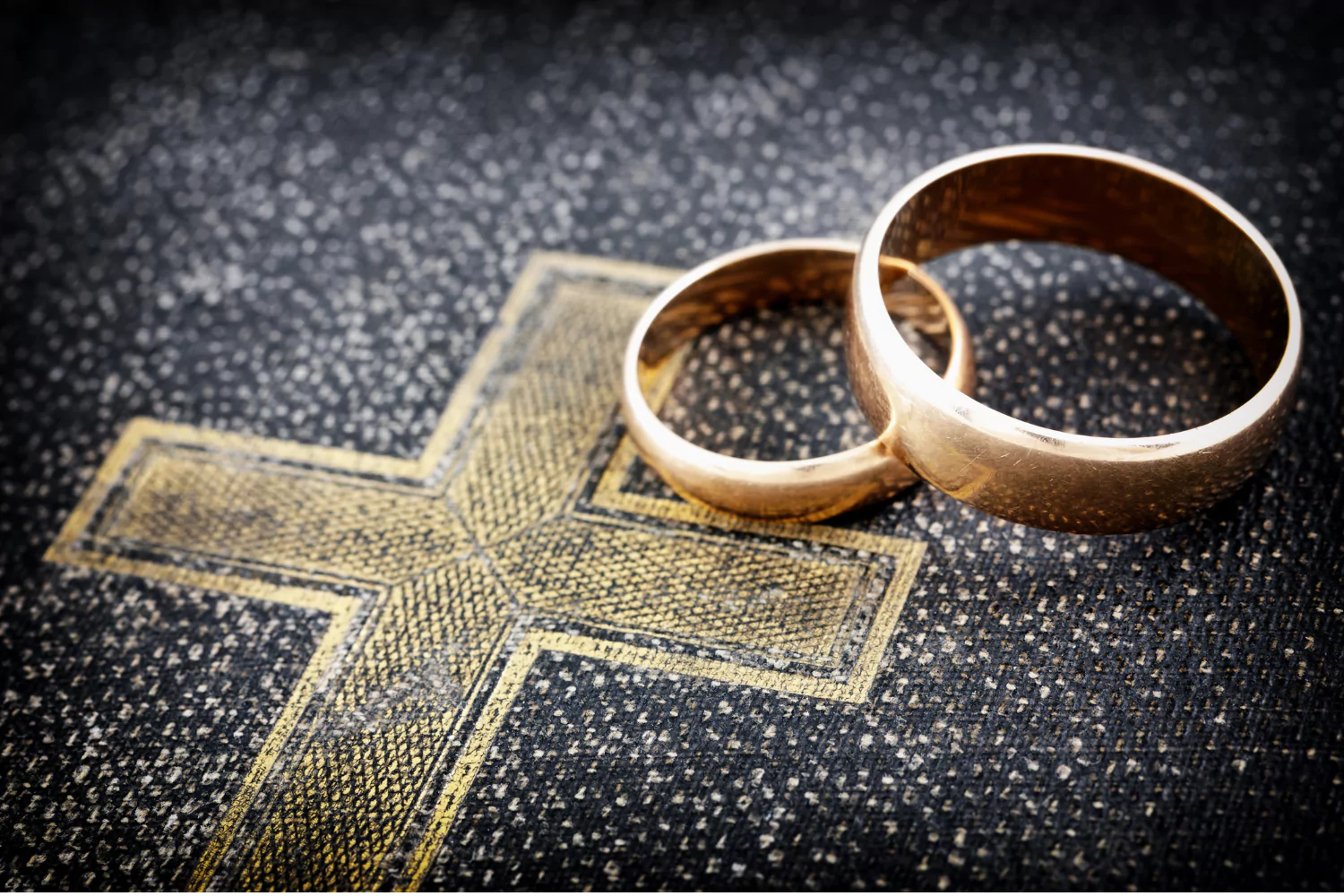 wedding rings sitting on Bible, symbolizing a pastor's marriage